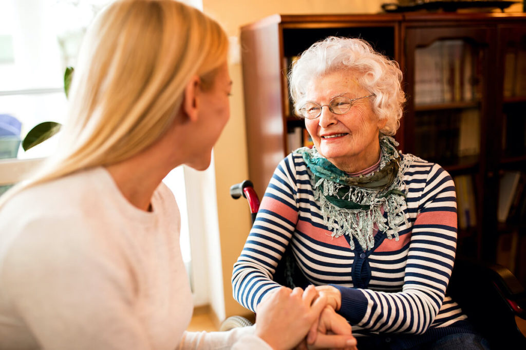 A senior woman and her daughter at a memory care community in Parma
