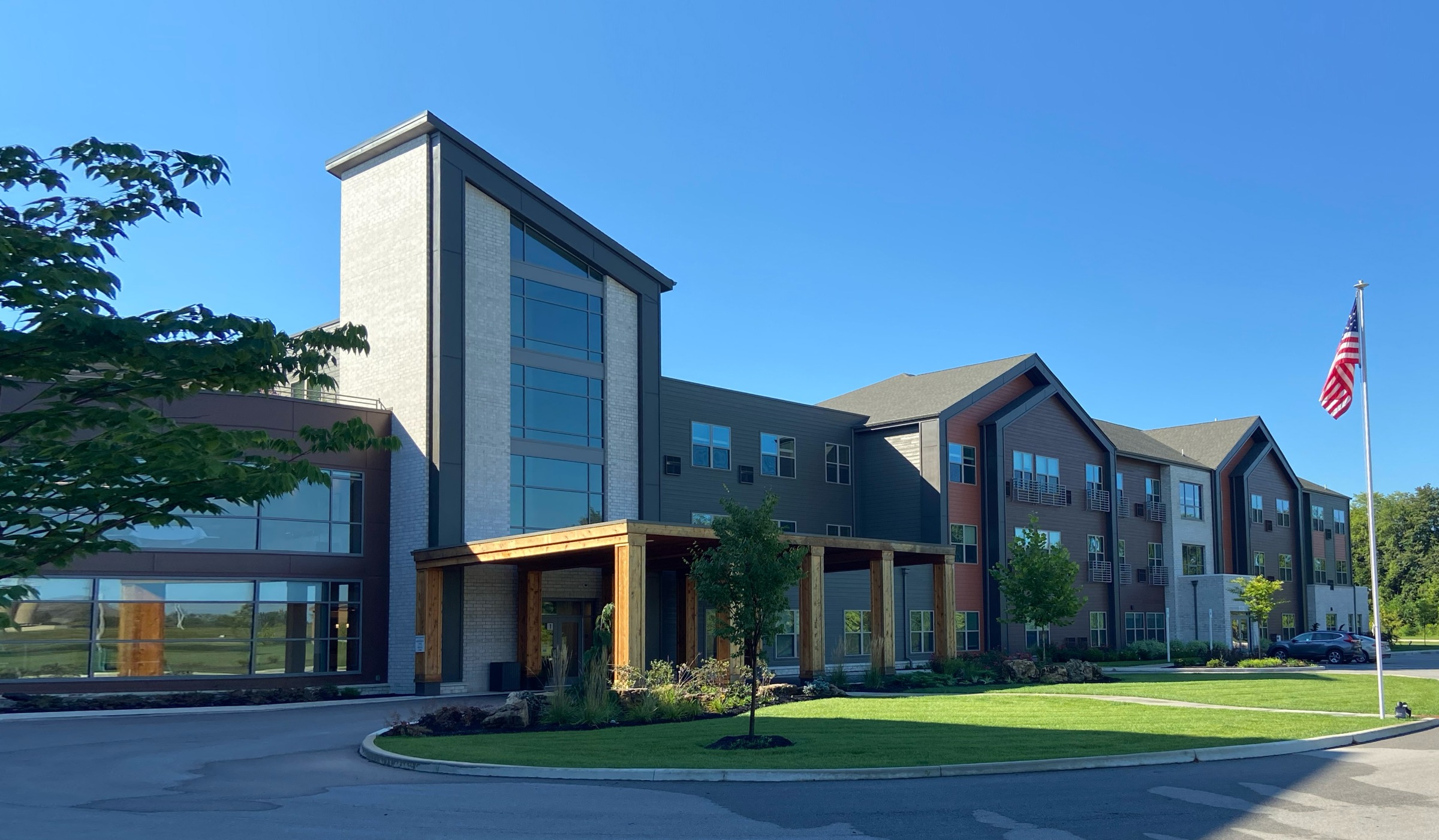 Modern apartment building with American flag outside