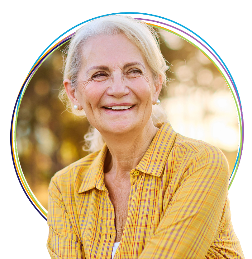 Smiling senior woman in yellow plaid shirt outdoors