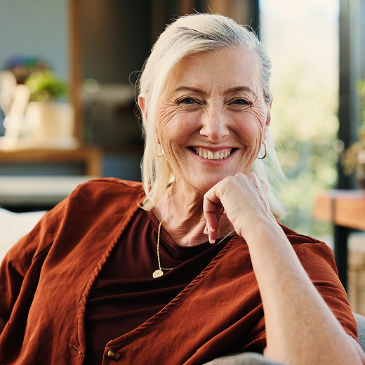 Smiling gray-haired woman sitting indoors