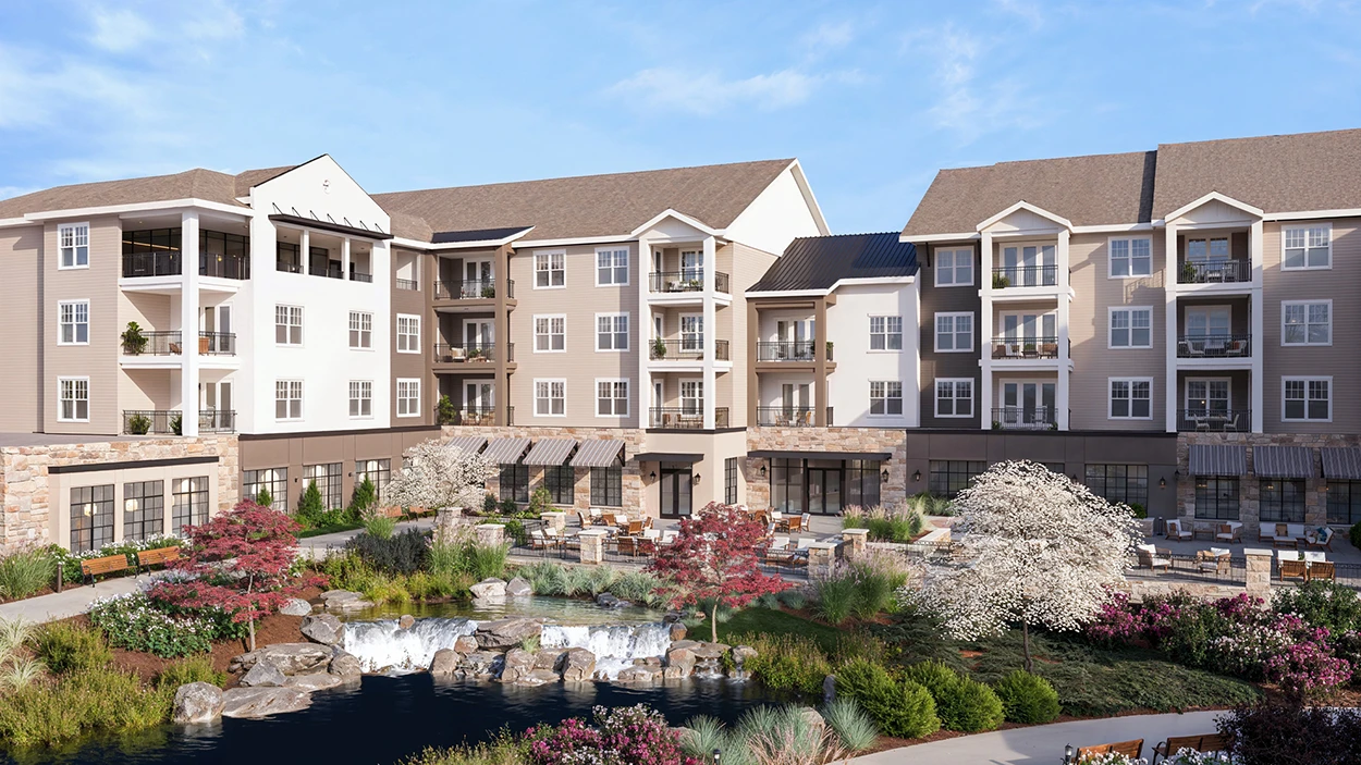 Modern apartment complex with landscaped courtyard and pond