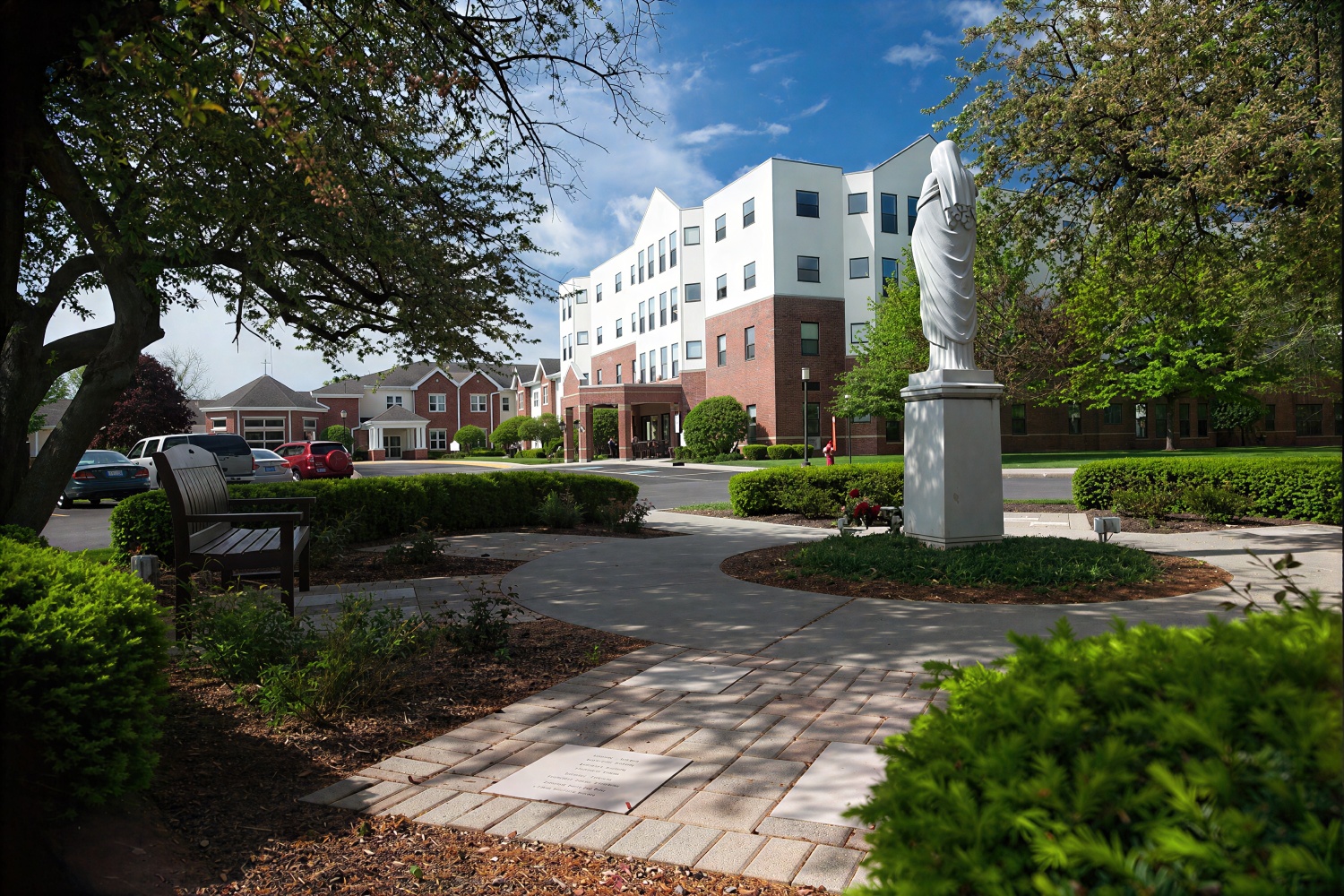 Statue in courtyard outside modern brick building
