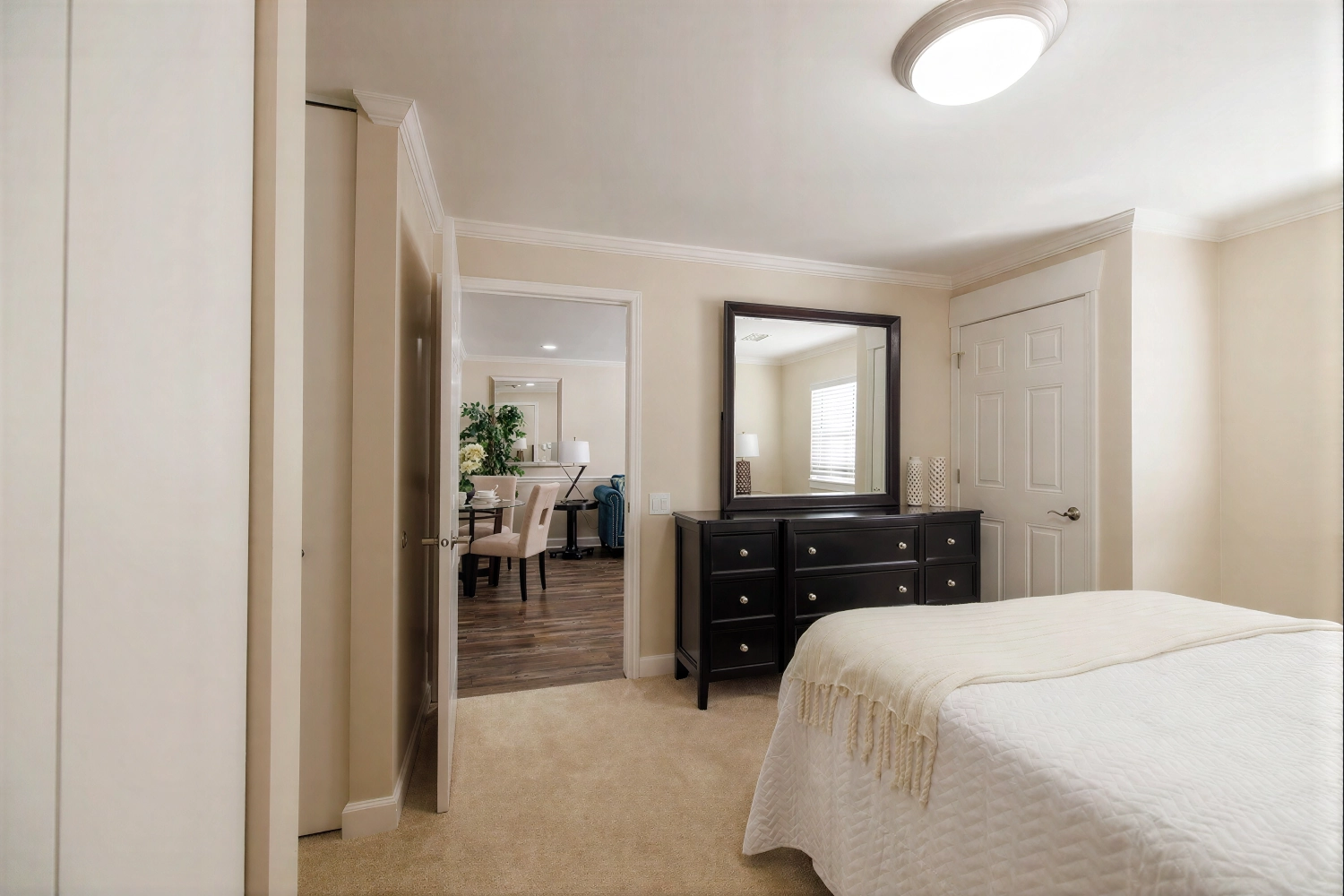 Beige bedroom with dresser and mirror