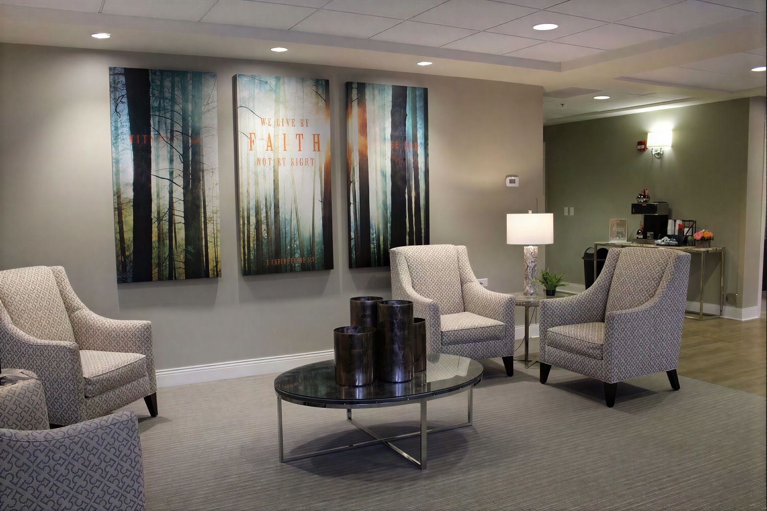 Modern waiting room with armchairs and forest wall art