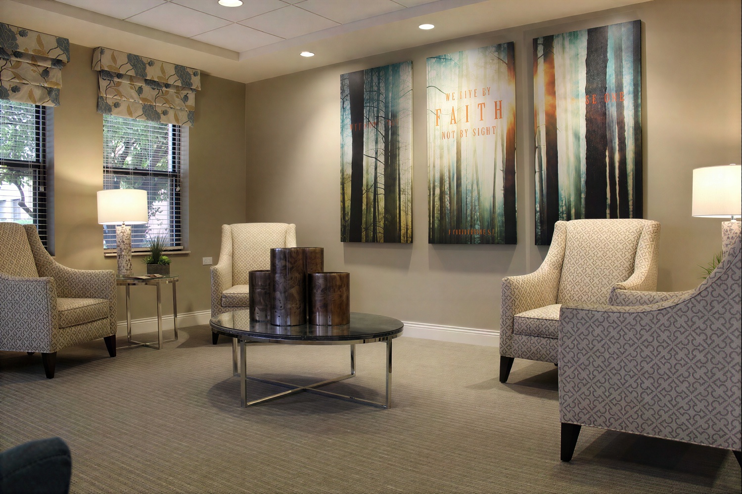 Modern waiting room with chairs and forest wall art