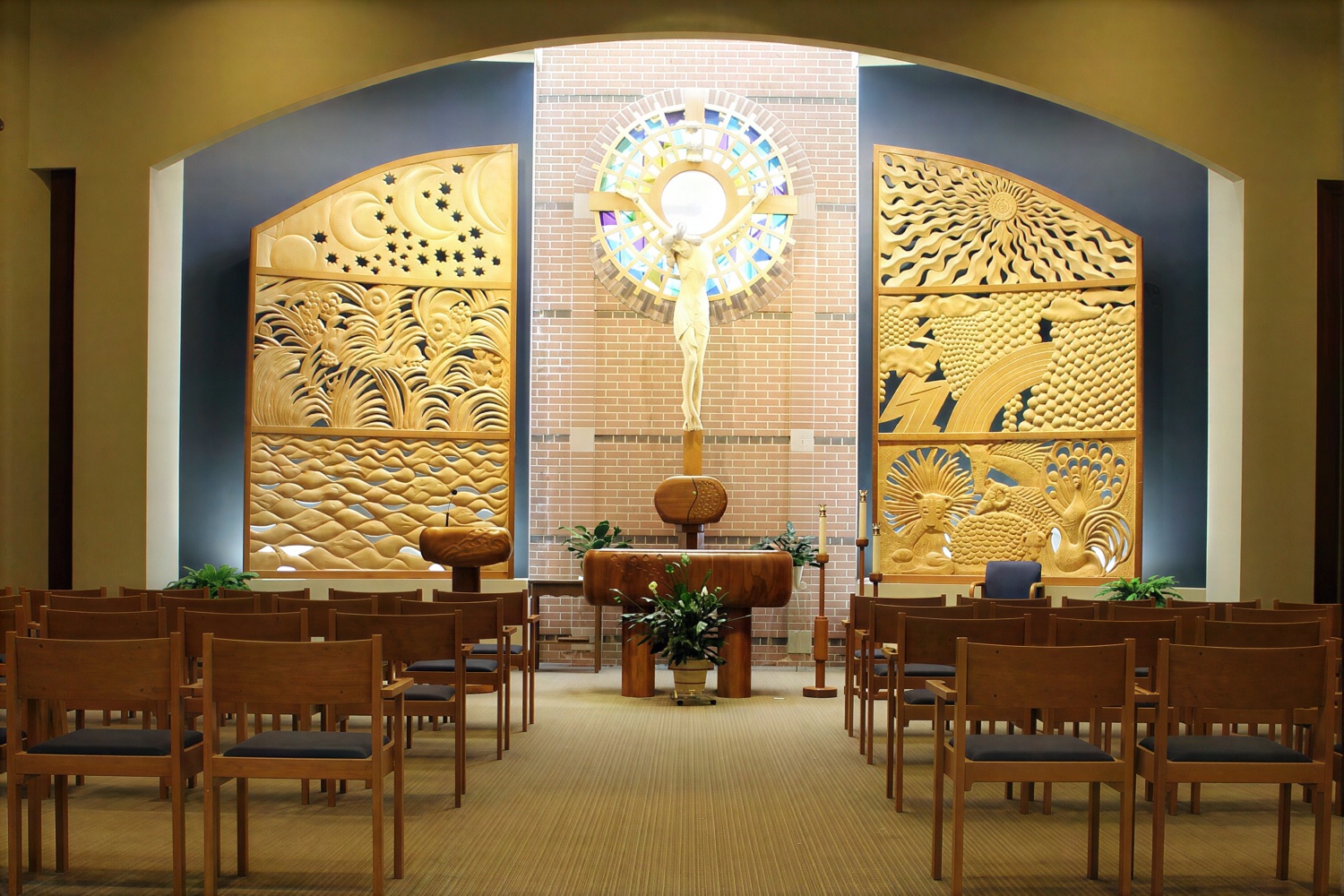 Church altar with crucifix and carved wall panels