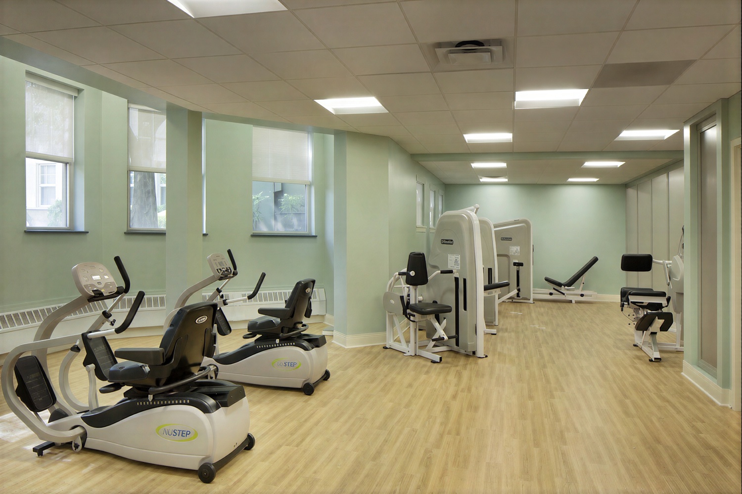 Modern rehabilitation gym with exercise machines and bikes