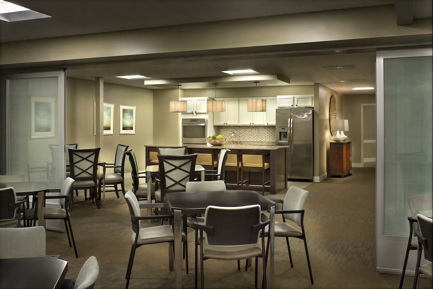 Modern communal kitchen and dining area with tables