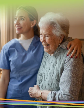 Caregiver embracing smiling elderly woman indoors