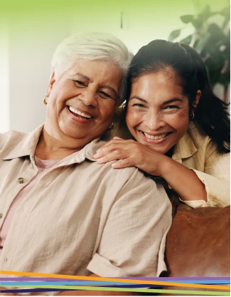 Two women smiling together on a couch