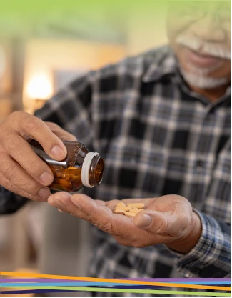 Man pouring pills from bottle into hand