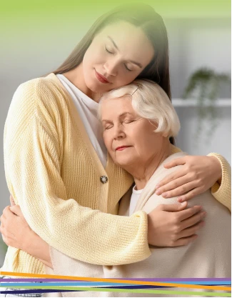 Young woman hugging elderly woman affectionately indoors