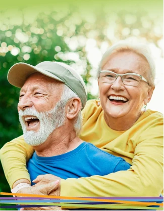 Happy elderly couple laughing outdoors together