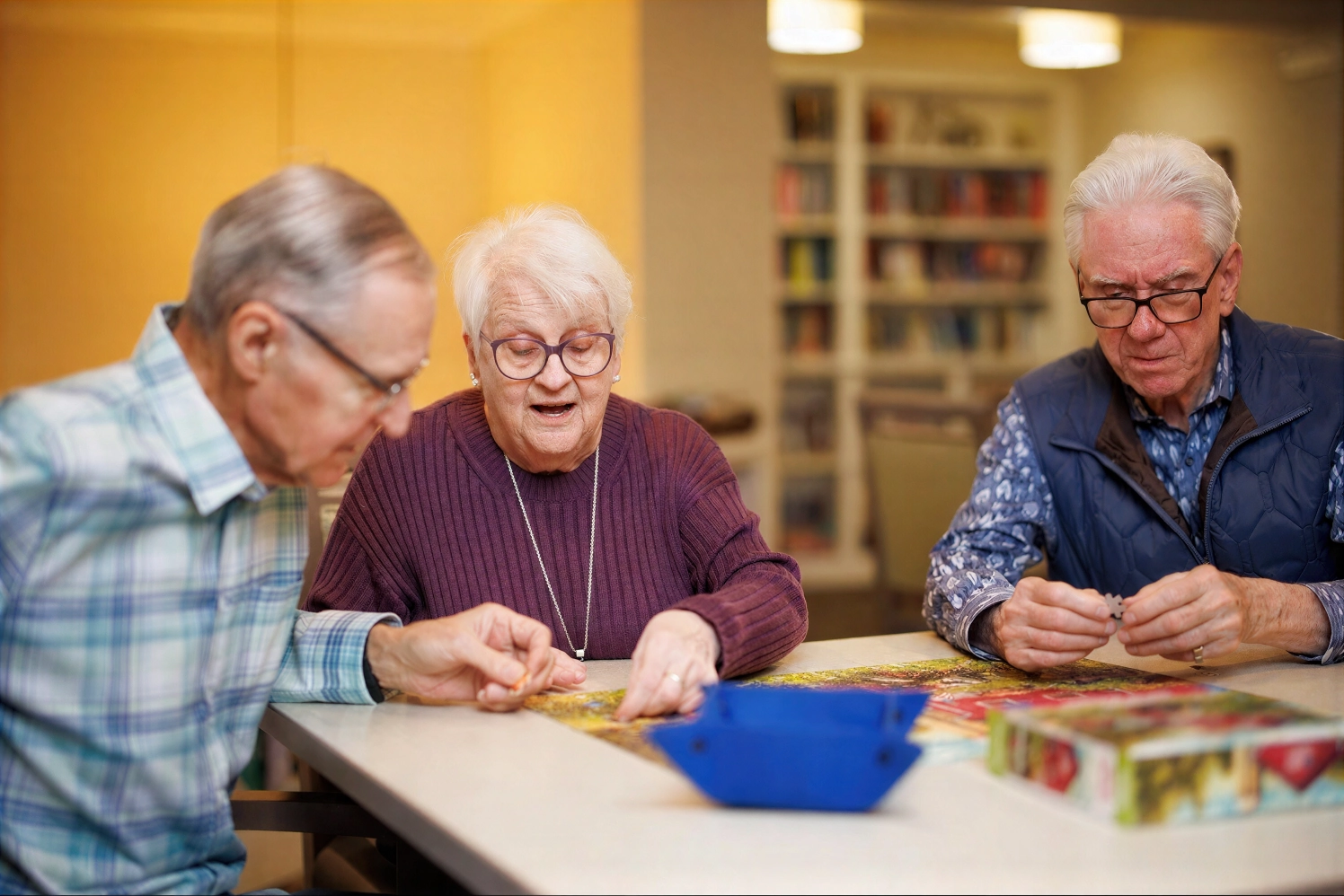 Three seniors working on a jigsaw puzzle