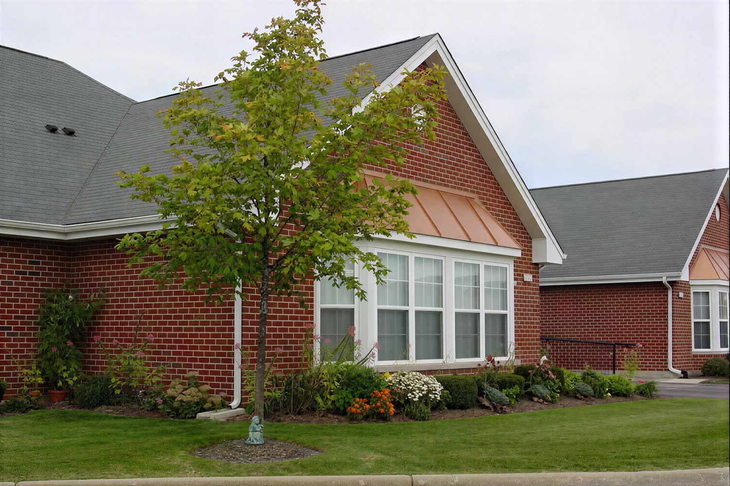 Brick suburban home with landscaped front yard