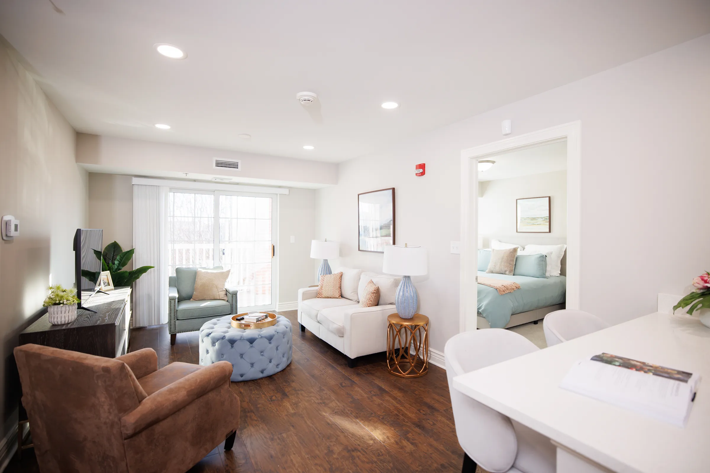 Bright modern living room with adjacent bedroom view