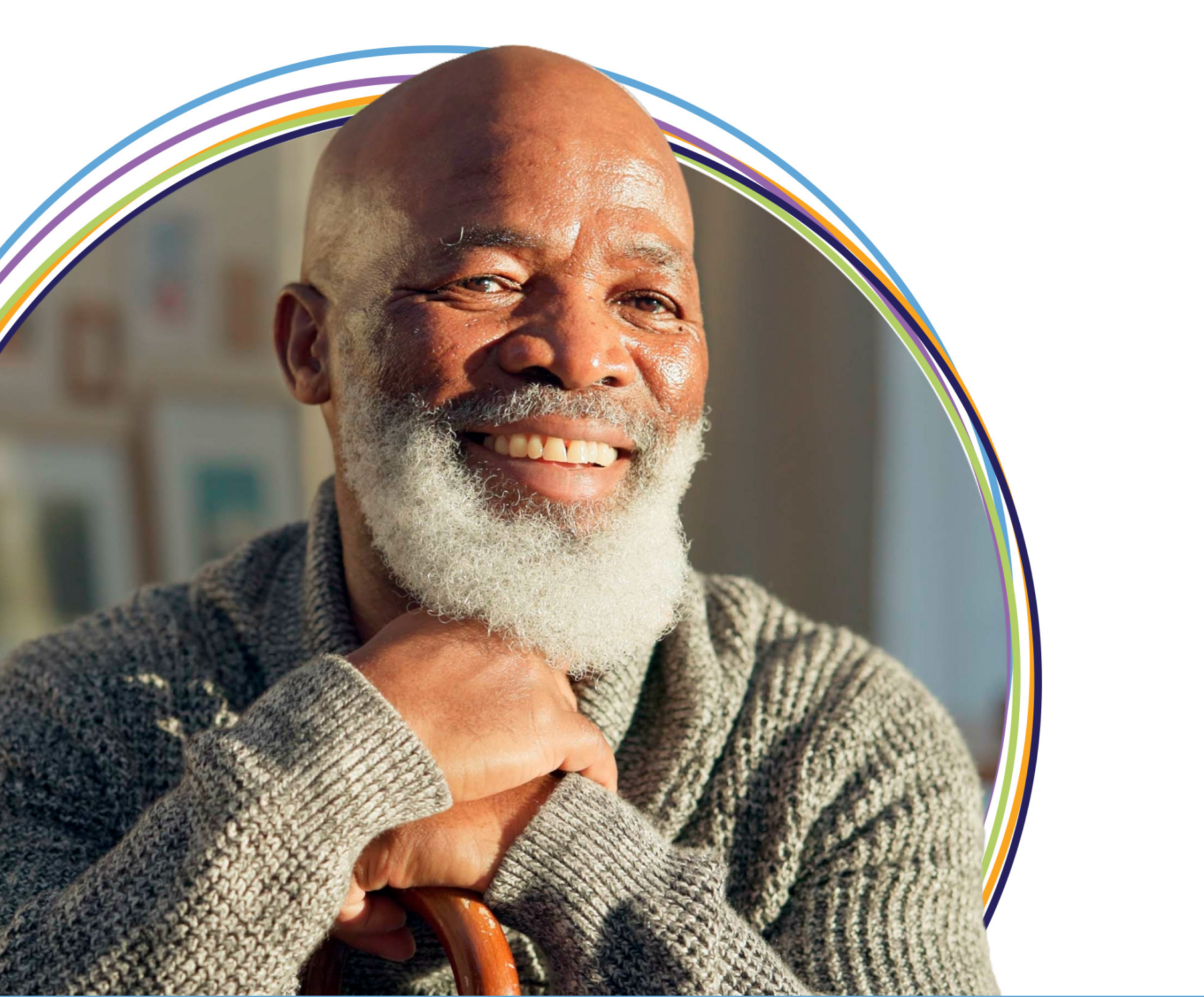 Smiling older man with white beard and cane