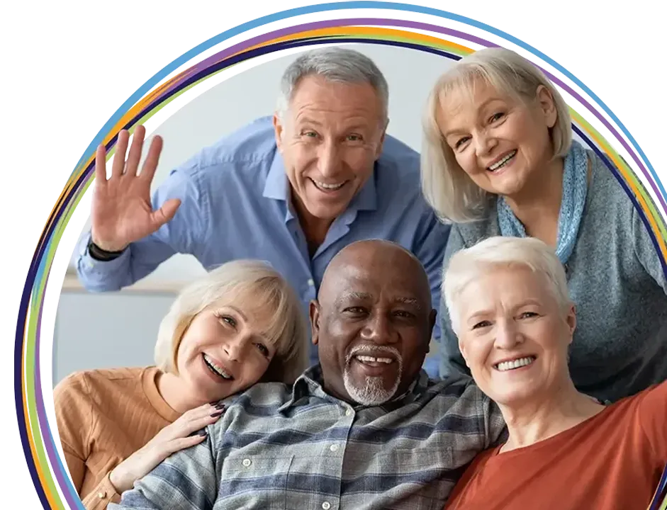 Five smiling seniors posing inside rainbow circle frame