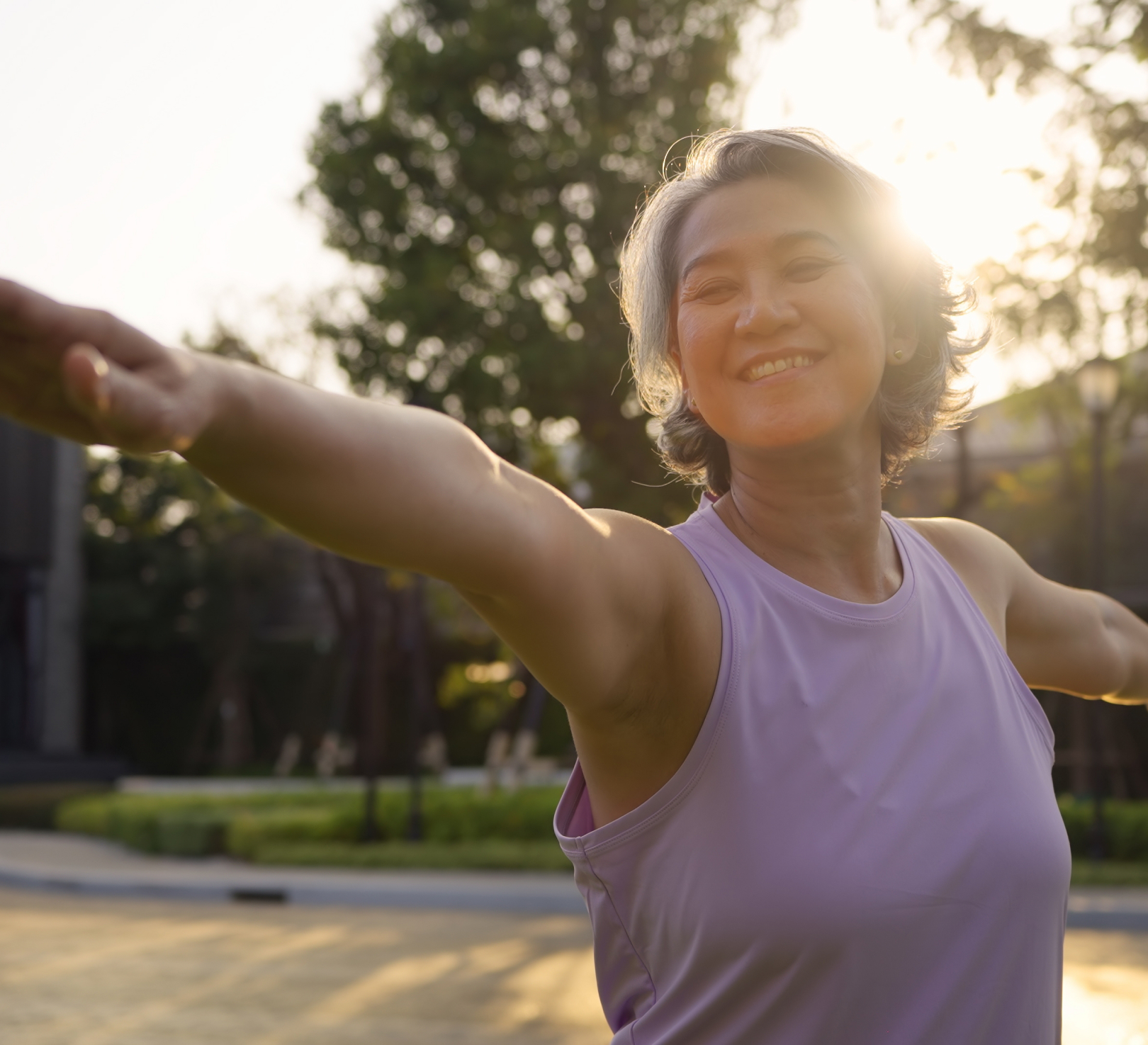 Smiling woman stretching outdoors at sunset