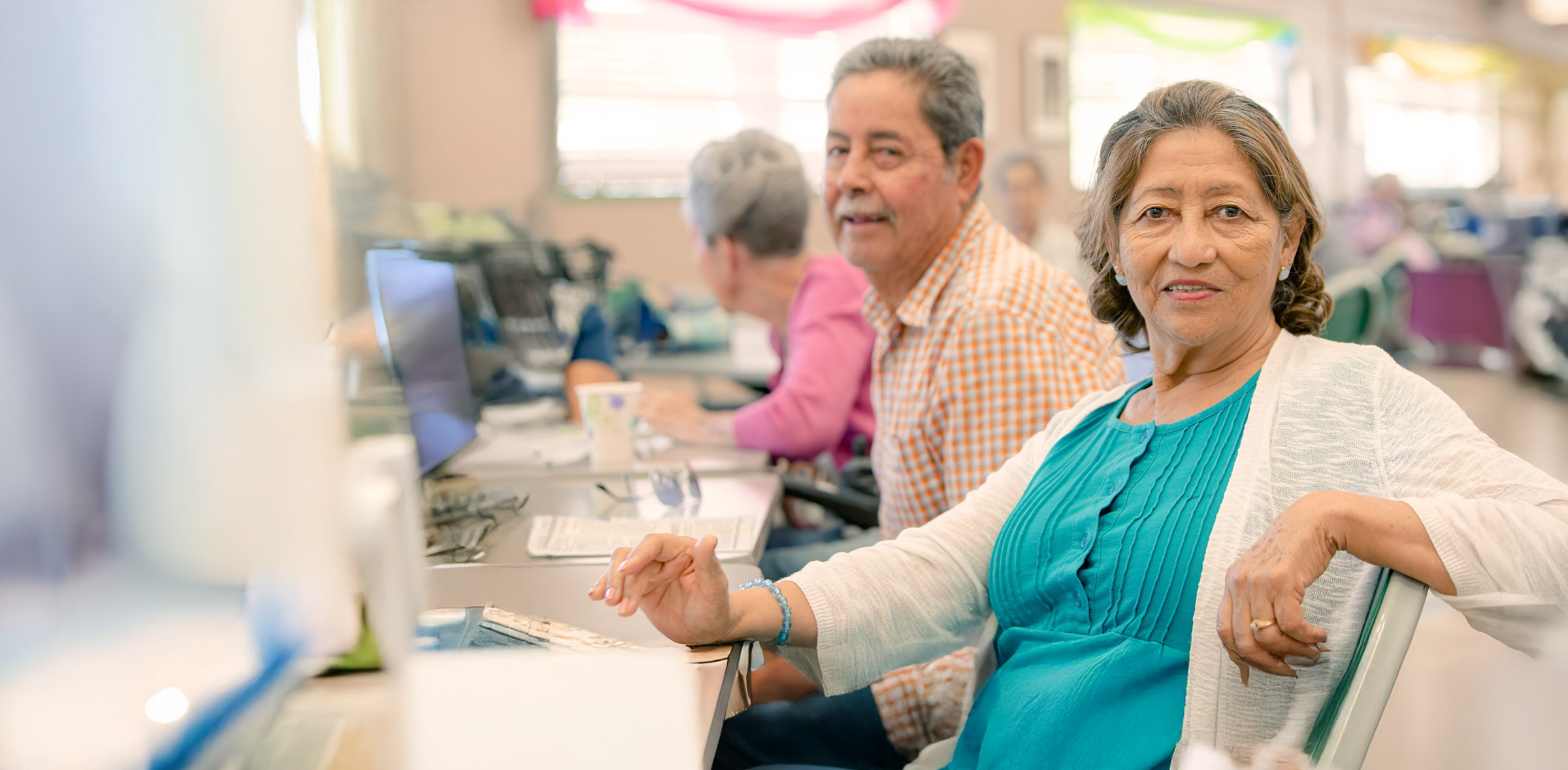 Senior woman smiling at computer class