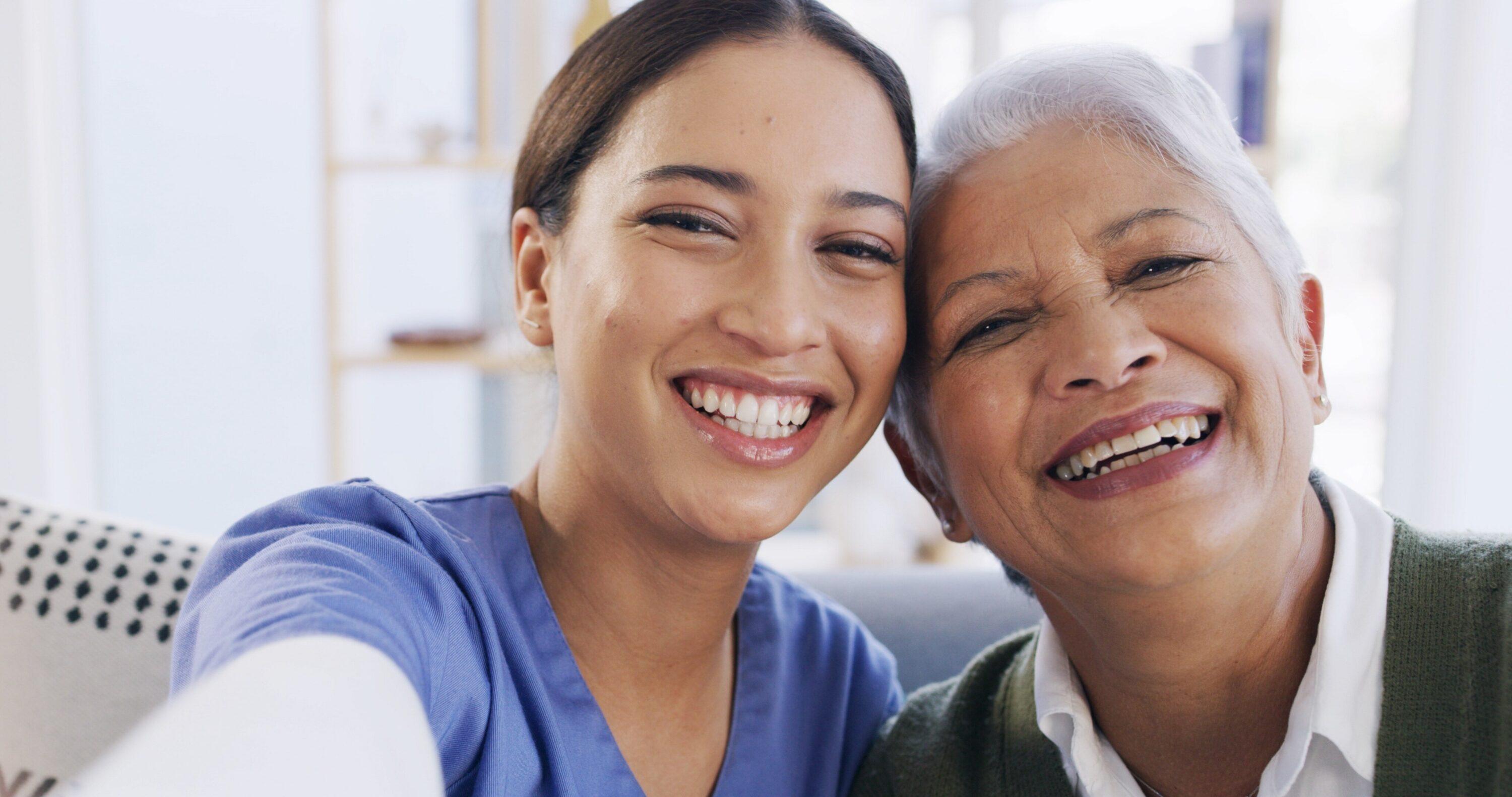 Smiling young woman and senior woman taking selfie