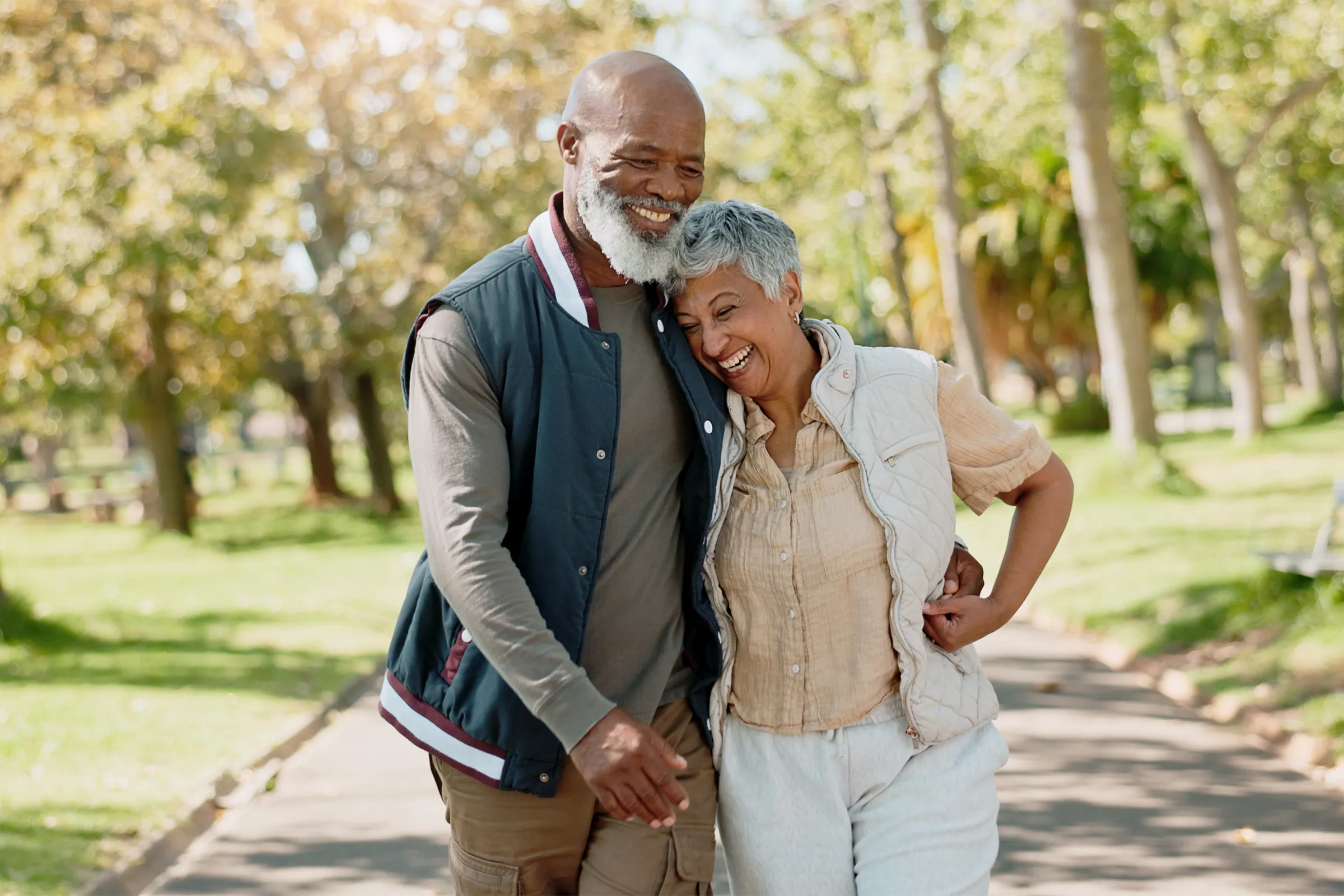 Senior couple walking arm in arm in park