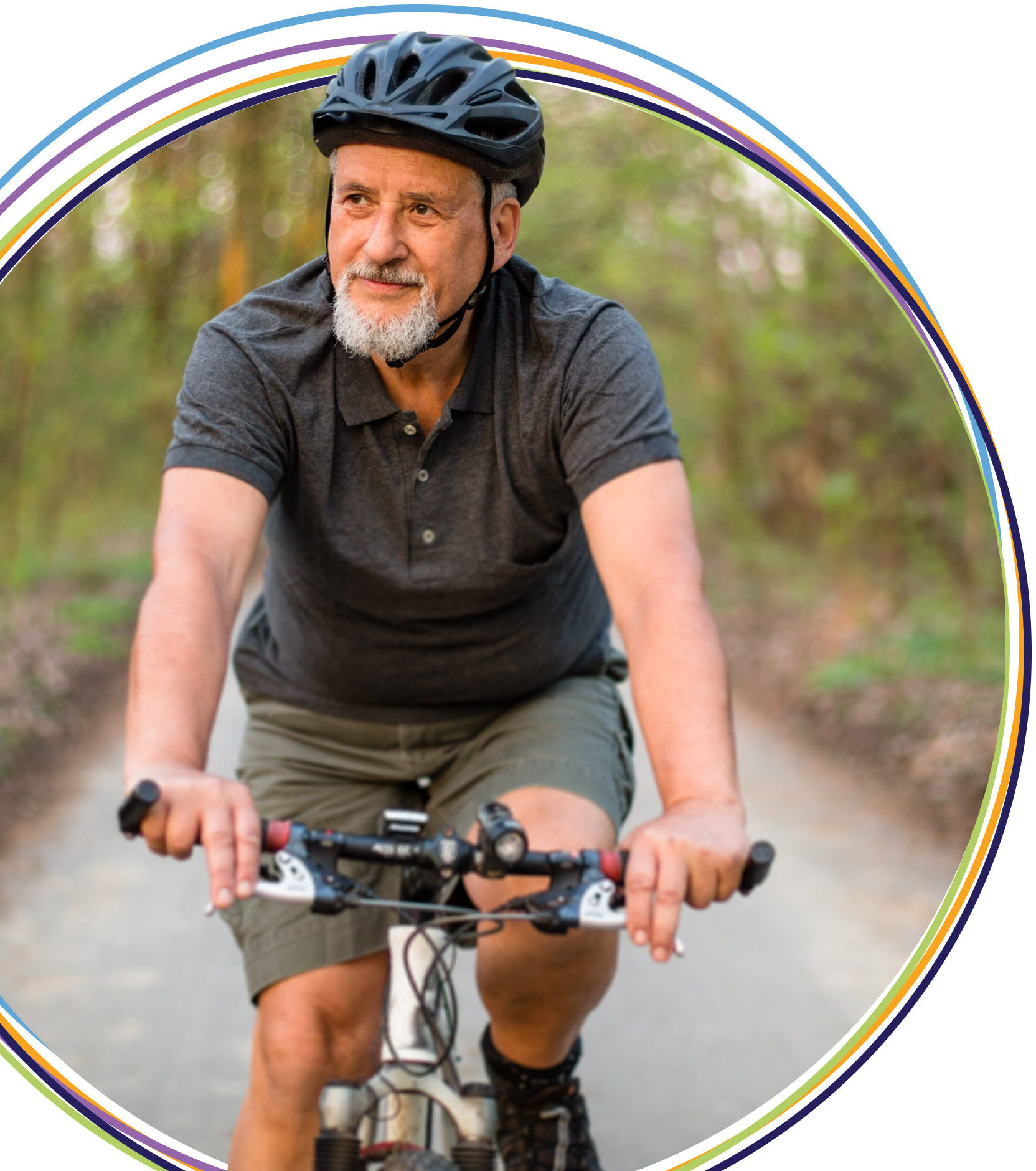 Man wearing helmet riding bicycle on forest trail