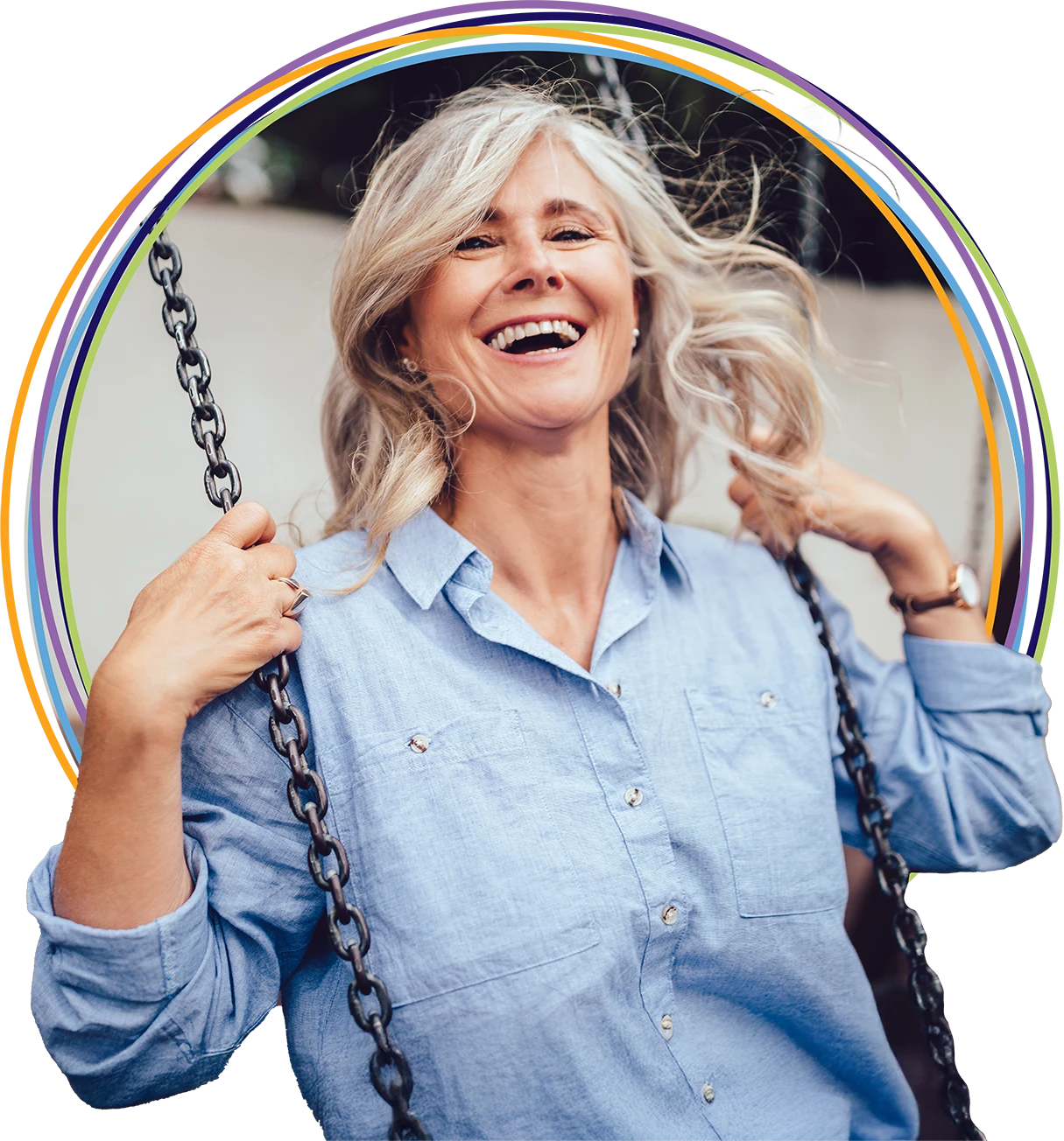 Smiling gray-haired woman on playground swing