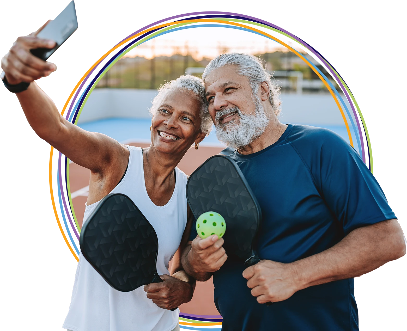 Senior couple taking selfie on pickleball court