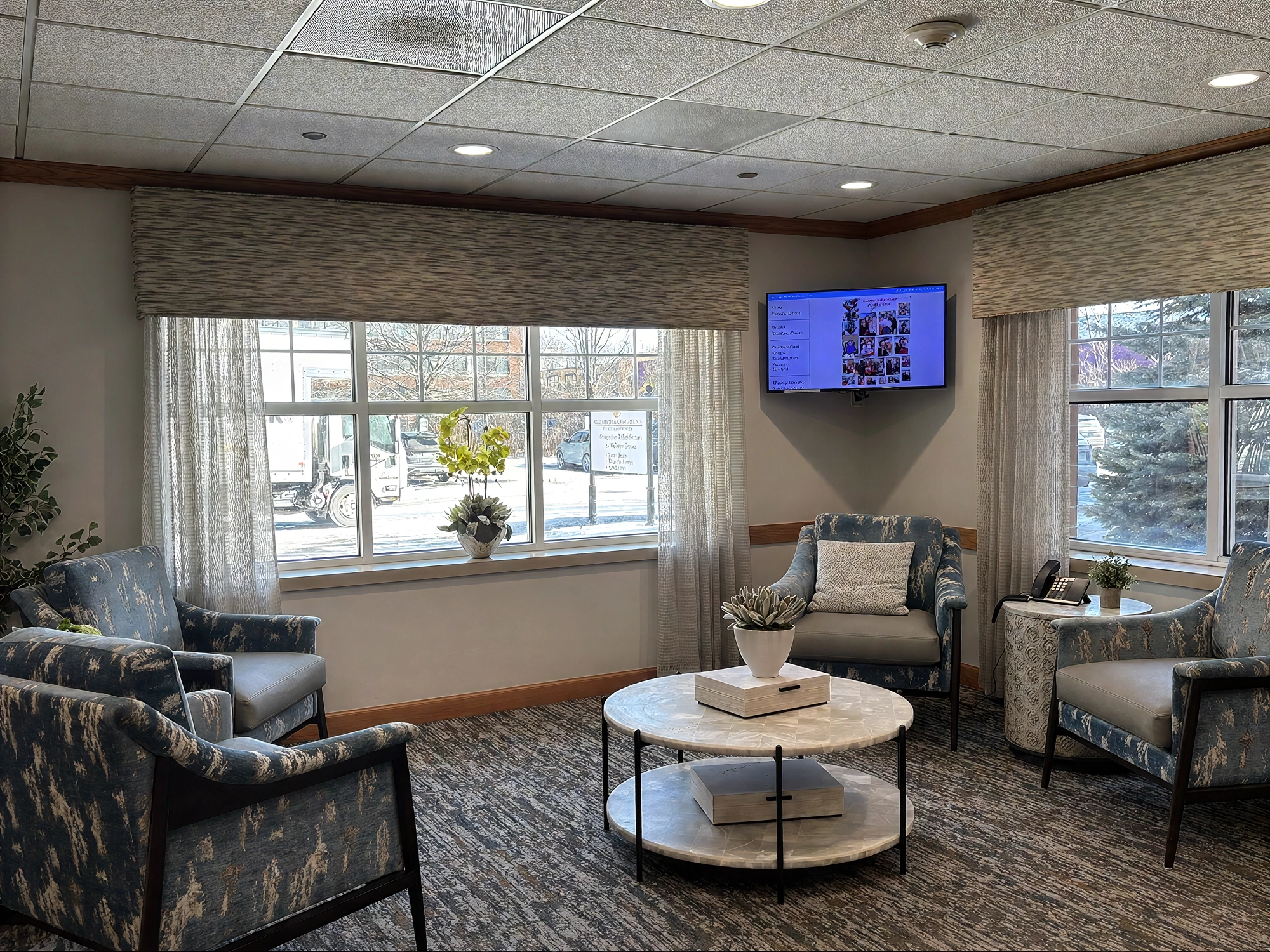 Cozy waiting room with armchairs and large windows