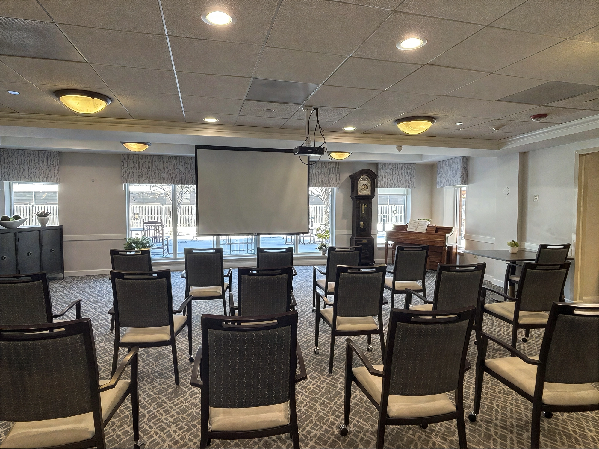 Small meeting room with chairs and projector screen