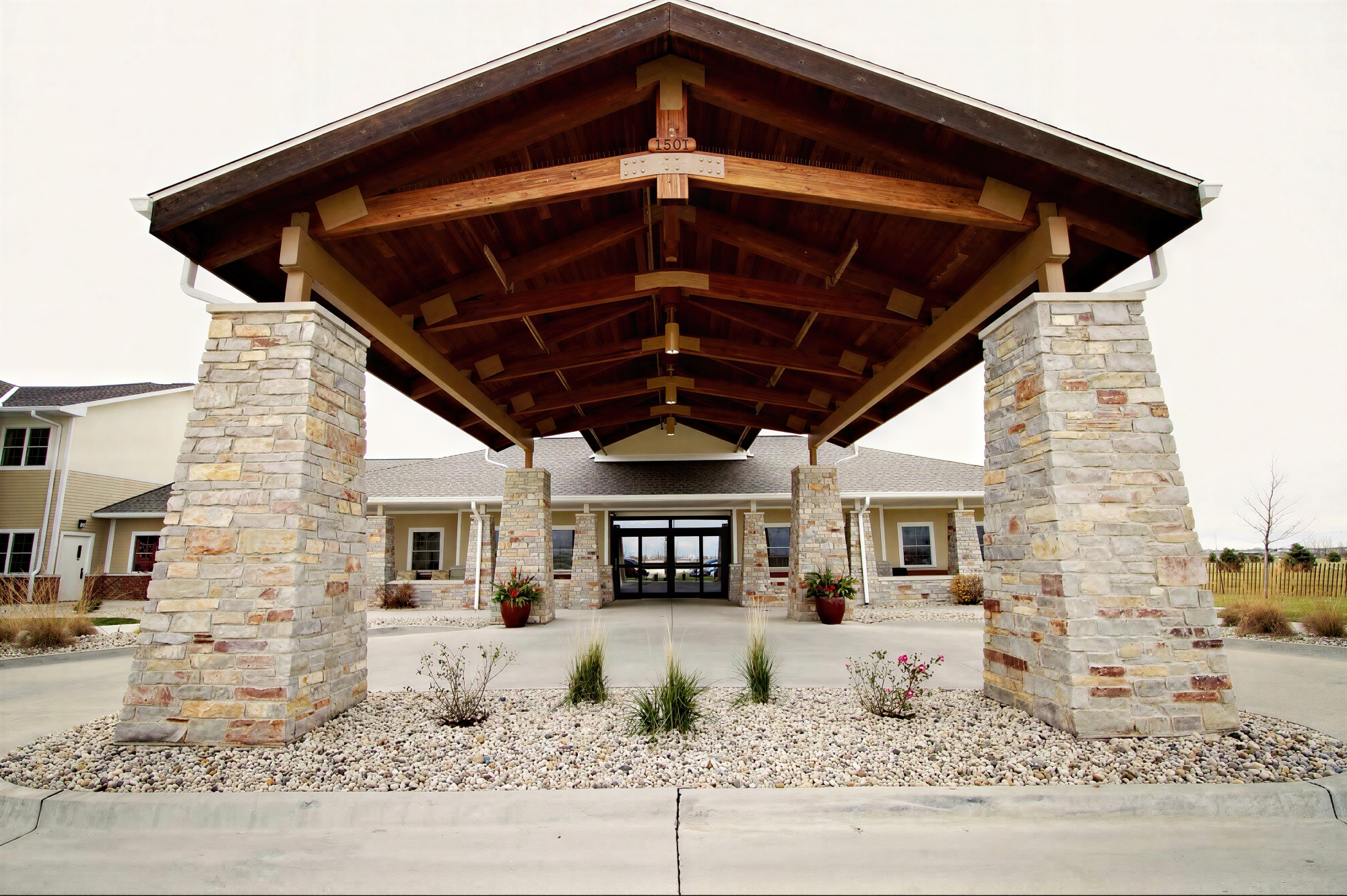 Stone column entrance with large wooden canopy