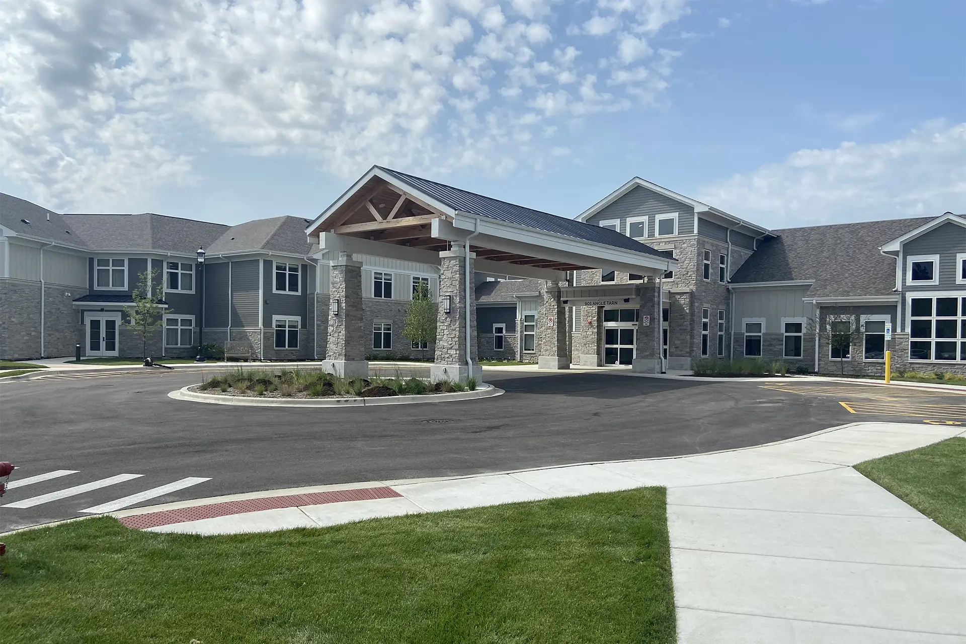 Modern apartment building with covered stone entrance